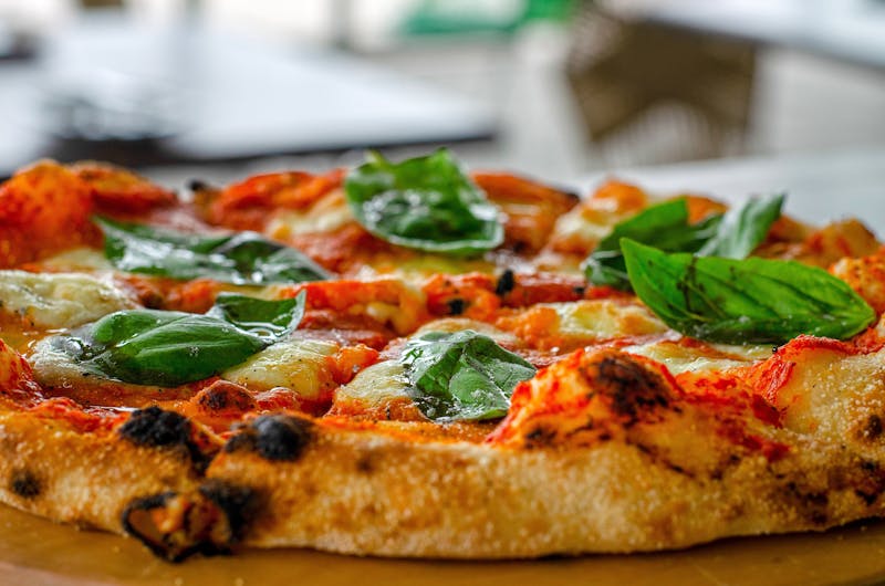 Punch Margherita Neapolitan pizza with fresh basil and buffalo mozzarella