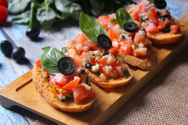 Bruschetta al Pomodoro with tomatoes, basil and olive oil on toasted bread